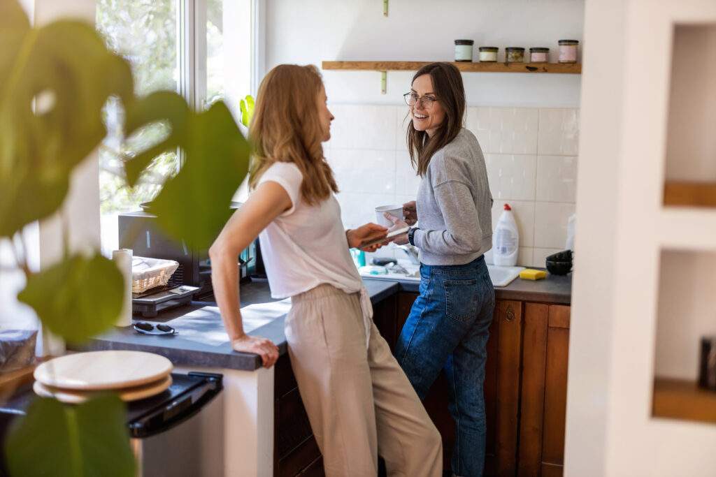 Right To Buy Scheme Female couple chatting in kitchen